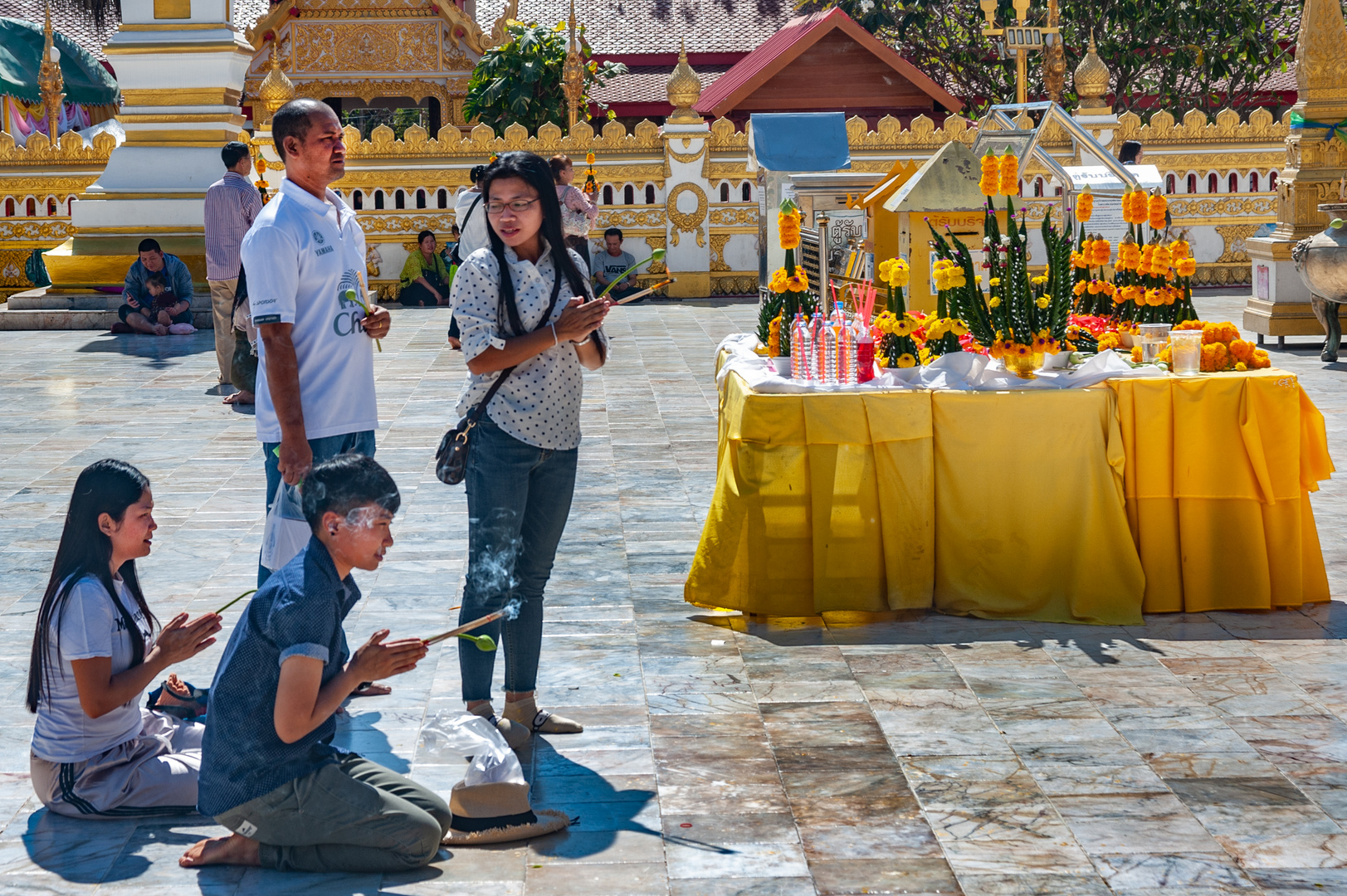 Worshippers pray in front of the chedi