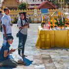 Worshippers pray in front of the chedi