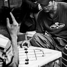 www.im-in-manila.jimdo.com - Larong dama (Filipino checkers game) with bottle caps as game pieces. 