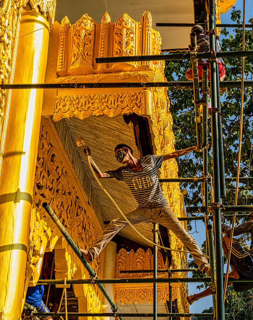 Yangon worker brush paint Golden Pagoda