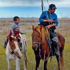 Young boy learns riding the horse