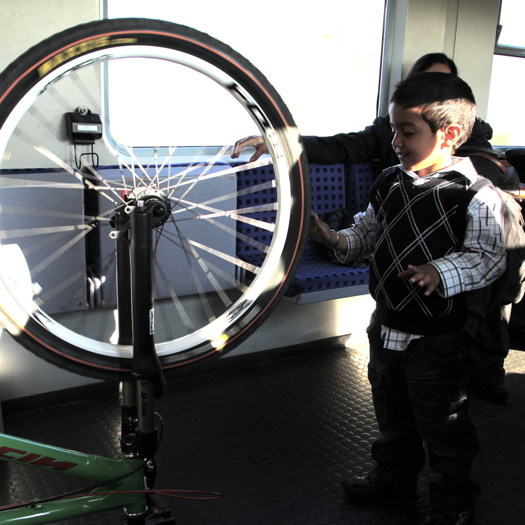 Young Boy playing with Bike Wheel