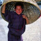 Young boy using his basket as an hat