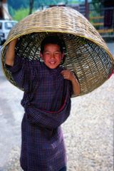 Young boy using his basket as an hat