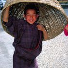 Young boy using his basket as an hat