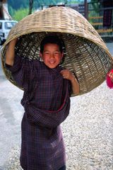 Young boy using his basket as an hat