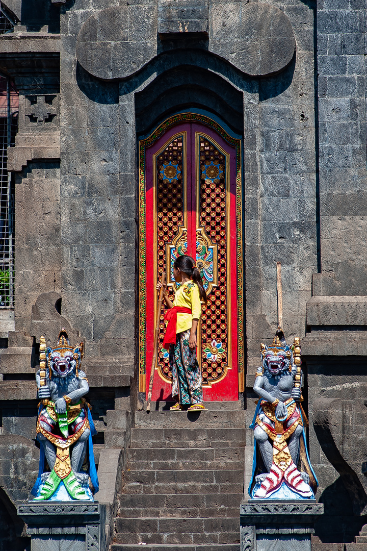 Young girl in front of the entrance gate