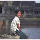 Young girl sitting in front of Angkor Wat