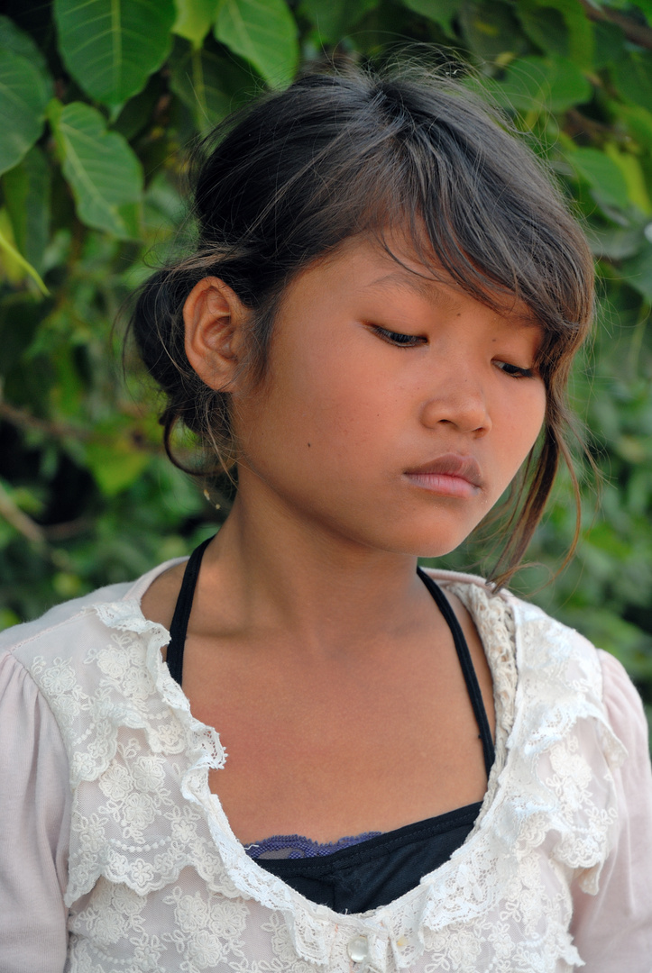 Young Khmer girl is selling baby corn