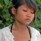 Young Khmer girl is selling baby corn