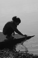 young lady playing to the water