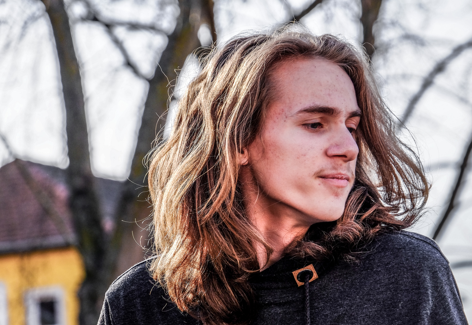 Young man and yellow house