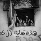 Young people in Benghasi, celebrating in the former Qatiba with flag of liberation