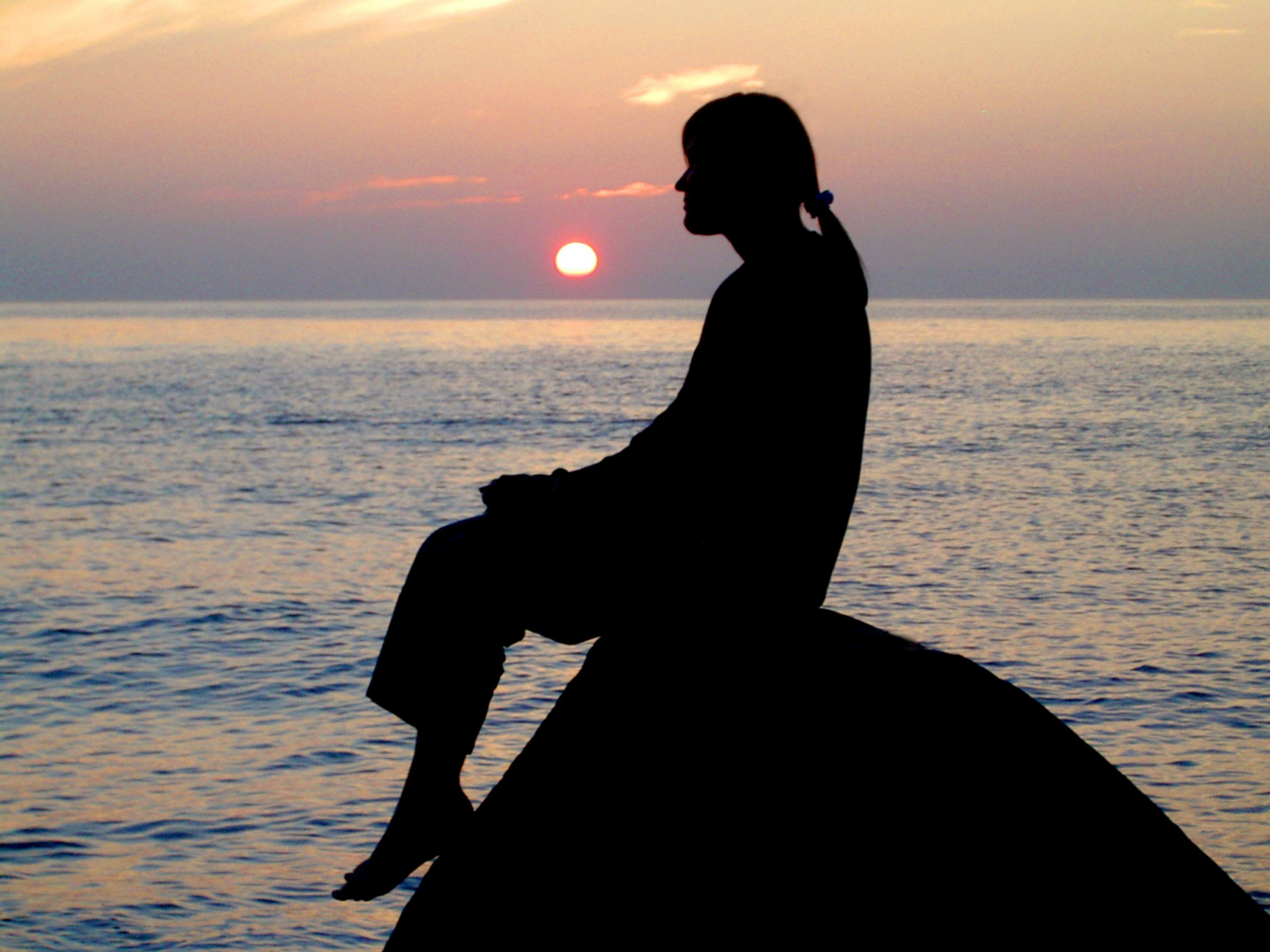 young woman at baltic Sea coast at Sundown