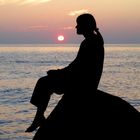 young woman at baltic Sea coast at Sundown