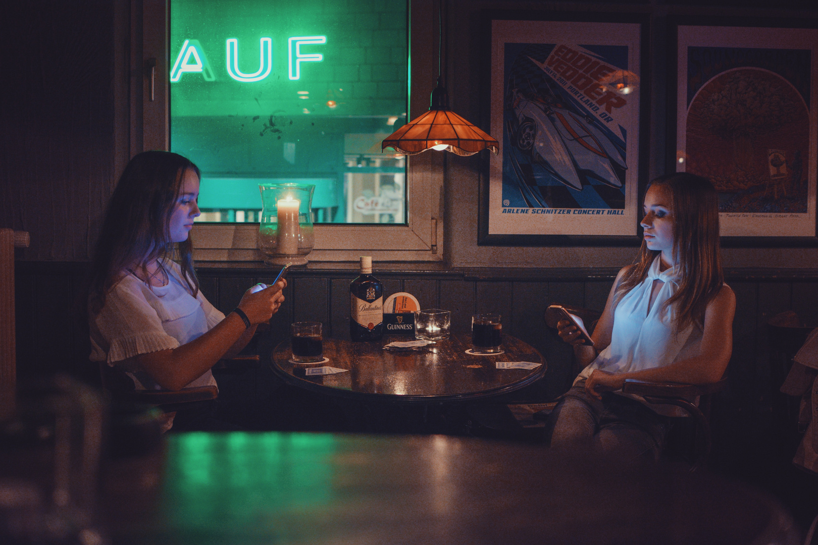 Zwei Frauen in einer Bar, aber nur am Handy