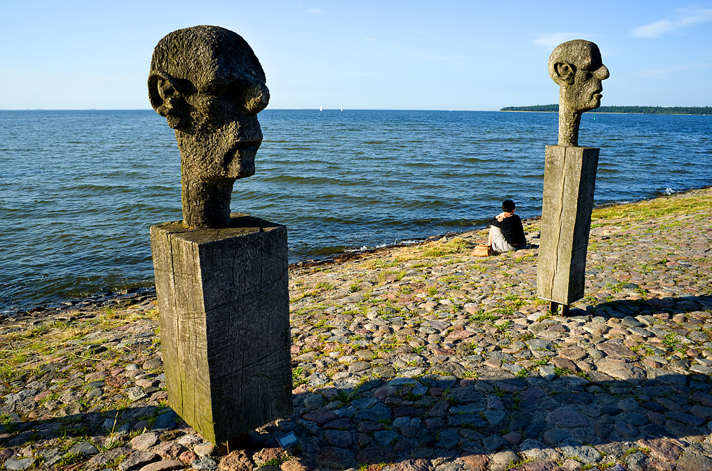 Zwei Holzköpfe und eine schöne Frau